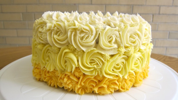 yellow ombre swirled frosting flowers cake